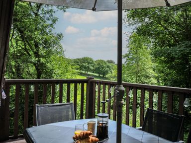 A table with drinks and pastries on a balcony at Hideaway Cottage, St Ann's Chapel, Cornwall