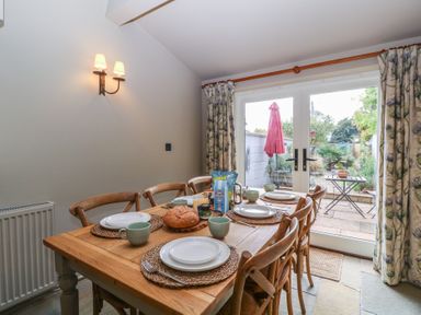 A dining room with a table set for a meal at Mallards in Bourton-On-The-Water
