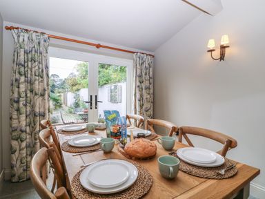 A dining room with a table set for a meal at Mallards in Bourton-On-The-Water