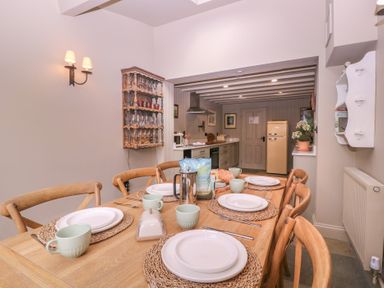 A dining room with a table set for meals at Mallards in Bourton-On-The-Water