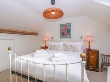 A bedroom with a double bed and nightstands at Mallards Bourton-On-The-Water