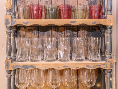 A shelf displaying various glasses at Mallards Bourton-On-The-Water