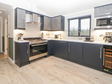 A kitchen with stove oven microwave coffee maker and sink at Meadow Lodge in Lifton