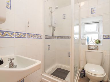 A bathroom with a shower and toilet at Menuchah in Criccieth