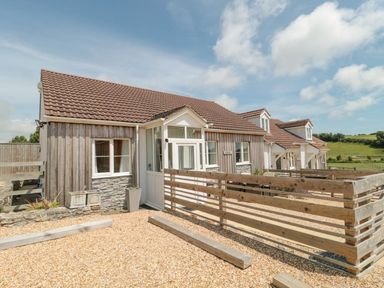 A row of cottages with tiled roofs wooden fences and gravel yards at Garland in Nottington near Weymouth