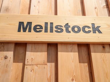 A wooden sign with the word Mellstock on a wooden wall at Mellstock in Nottington near Weymouth