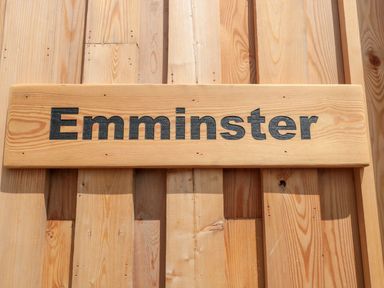 A wooden sign with the word Emminster on a wooden wall at Emminster in Nottington near Weymouth