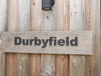 A wooden sign displaying the name Durbyfield in Nottington near Weymouth