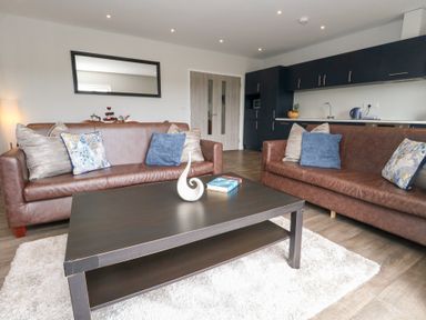 A living room with sofas and a coffee table at Durbyfield Nottington near Weymouth