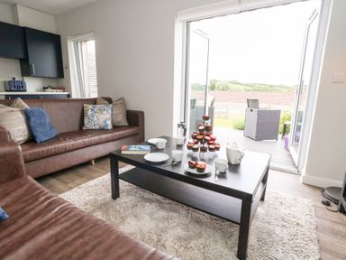 A living room with cupcakes on a table at Durbyfield in Nottington near Weymouth