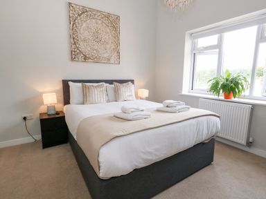 A bedroom with a bed and bedside tables at Durbyfield in Nottington near Weymouth