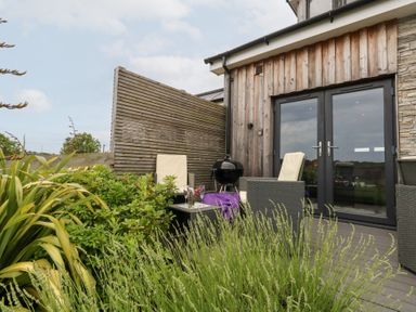 An outdoor area with chairs and a table at Durbyfield in Nottington near Weymouth