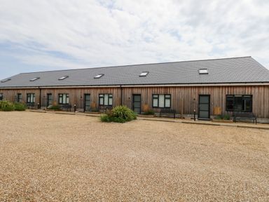A row of wooden buildings with windows and doors at Durbyfield in Nottington near Weymouth