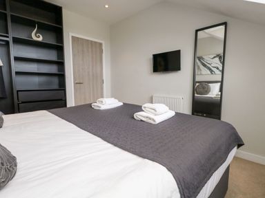 A bedroom with a bed and towels at Durbyfield in Nottington near Weymouth