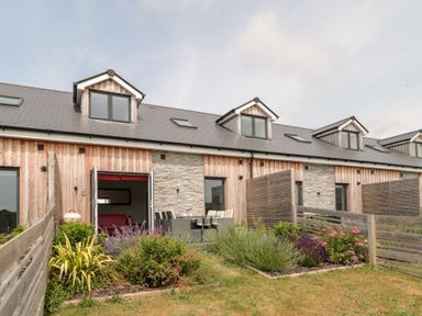 A house with a garden and patio area at Egdon Heath Nottington near Weymouth