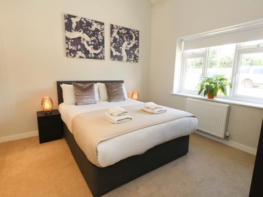 A bedroom with a bed and bedside tables at Overcombe Mill Nottington near Weymouth