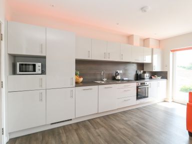 A kitchen with cabinets and appliances at Corvesgate in Nottington near Weymouth