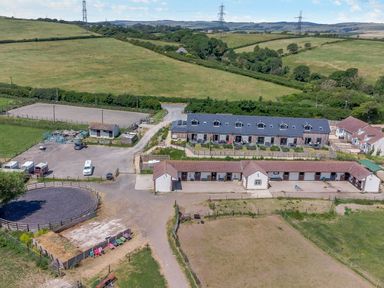 A rural farm with barns fields and outdoor riding arenas at Dirdale in Weymouth