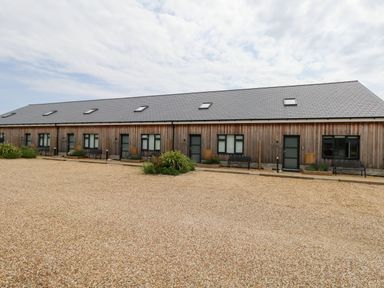 A building with multiple entrances and gravel area at Dirdale in Weymouth