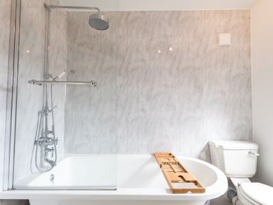 A bathroom with a bathtub, showerhead, and toilet at Anchor House in Weymouth