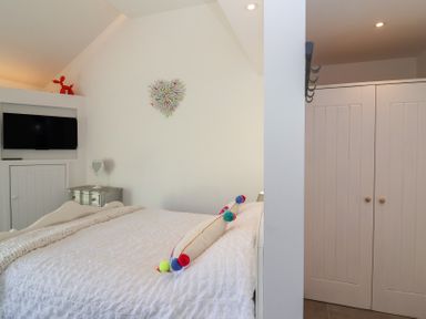 A bedroom with a bed and television at Ninky Nonk in Bristol