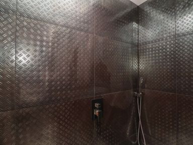 A shower with tiles and fixtures at Ninky Nonk in Bristol