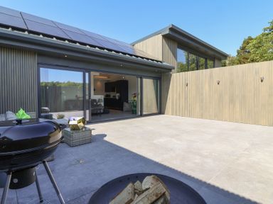 An outdoor space with a grill and sliding doors at Ninky Nonk in Bristol