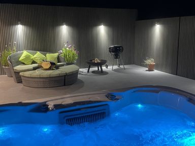 A hot tub with seating and a grill at Ninky Nonk in Bishop Sutton