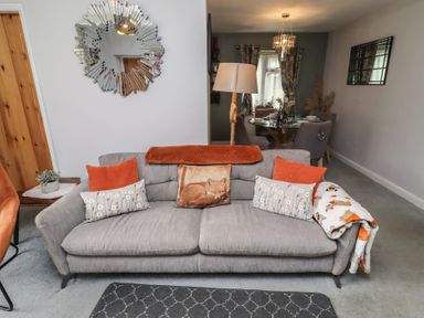 A living room with a sofa and dining area at Country Retreat in Ponteland