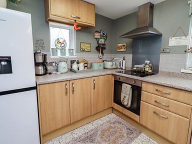 A kitchen with appliances and cabinet at Country Retreat Ponteland