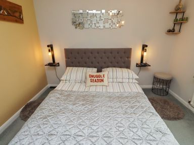 A bedroom with a bed and a nightstand at Country Retreat in Ponteland