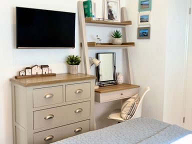 A bedroom with a desk and shelves at 11 The Gables in Lyme Regis