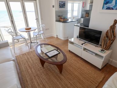 A living room with a view of the sea at Seagull in Lyme Regis