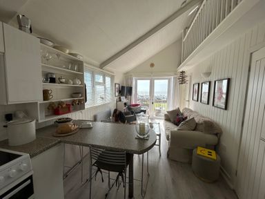 A living room with a couch and chairs at 8 Bowling Green Chalets Lyme Regis