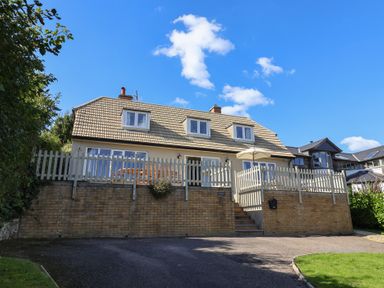 A house with a balcony and fence at Westhaven in Lyme Regis
