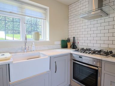 A kitchen with a sink and stove at Westhaven in Lyme Regis
