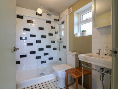 A bathroom with a shower, toilet, and sink at Westhaven in Lyme Regis