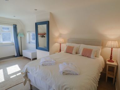 A bedroom with a bed and lamps at Westhaven in Lyme Regis