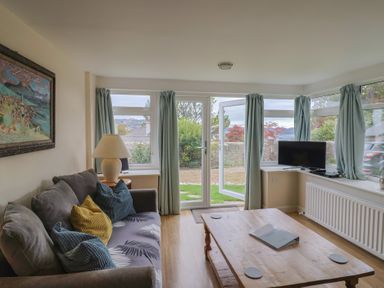 A living room with a sofa and coffee table at Penny Plot Cottage in Lyme Regis