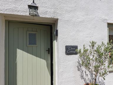 An entrance with a door and nameplate at Cleve Cottage in Lyme Regis