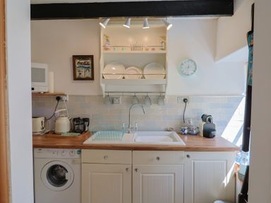 A kitchen with a sink and appliances at Cleve Cottage in Lyme Regis