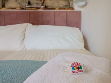 A bed with pillows and a towel in the bedroom at Cleve Cottage in Lyme Regis