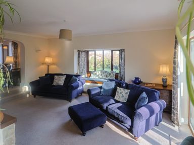 A living room with sofas and a coffee table at High Cliff Orchard in Lyme Regis