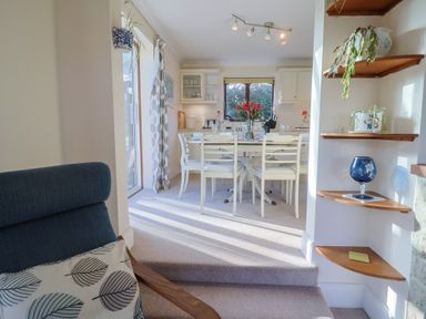 A dining room with a table and chairs at High Cliff Orchard in Lyme Regis