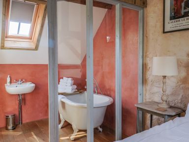 A bathroom with a bathtub and sink at The Stone Barn in Bridport