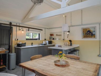 A kitchen with a table and chairs at The Dairy in Bridport