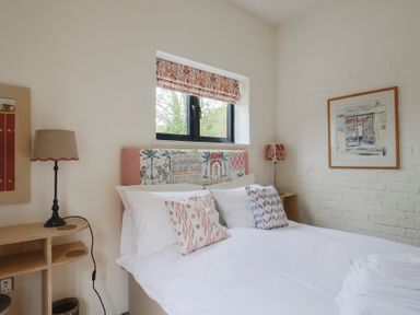 A bedroom with a bed and lamp at The Dairy in Bridport