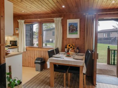 A dining room with a table set for meals at 10 Pinewood Retreat in Pinewood