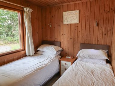 A bedroom with two beds and a window at 10 Pinewood Retreat in Pinewood