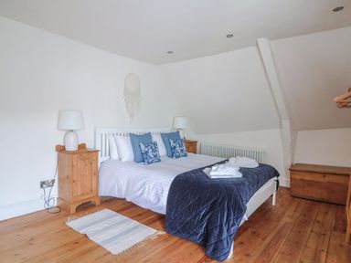 A bedroom with a bed and bedside table at The Little Rose in Lyme Regis
